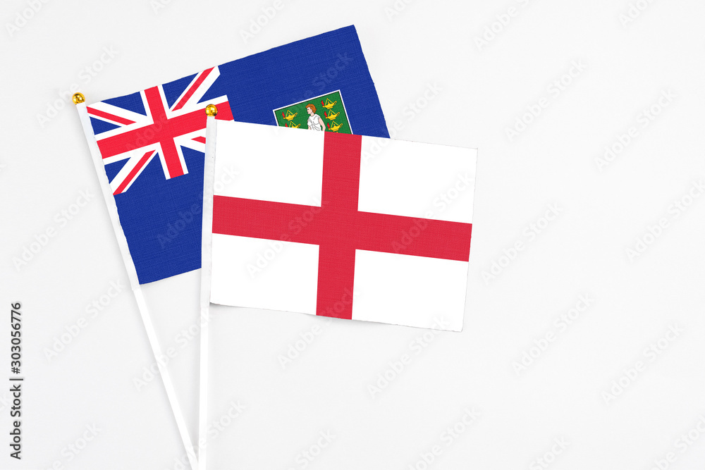 England and British Virgin Islands stick flags on white background. High quality fabric, miniature national flag. Peaceful global concept.White floor for copy space.