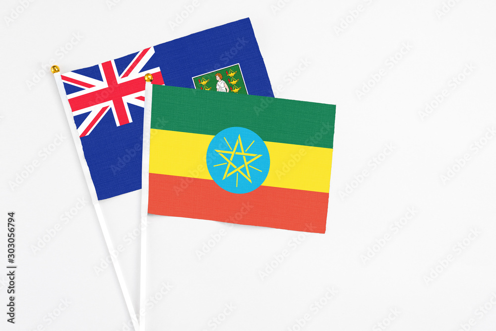 Ethiopia and British Virgin Islands stick flags on white background. High quality fabric, miniature national flag. Peaceful global concept.White floor for copy space.