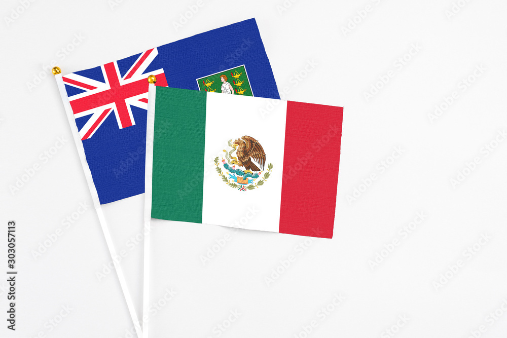 Mexico and British Virgin Islands stick flags on white background. High quality fabric, miniature national flag. Peaceful global concept.White floor for copy space.