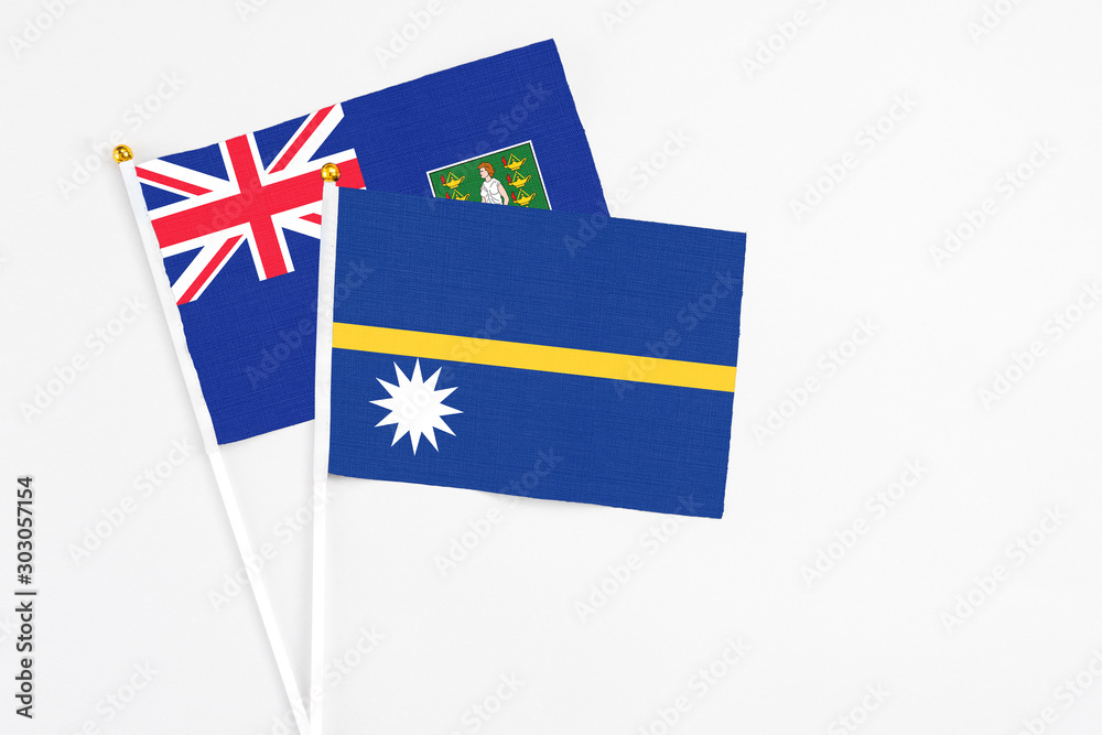 Fototapeta premium Nauru and British Virgin Islands stick flags on white background. High quality fabric, miniature national flag. Peaceful global concept.White floor for copy space.