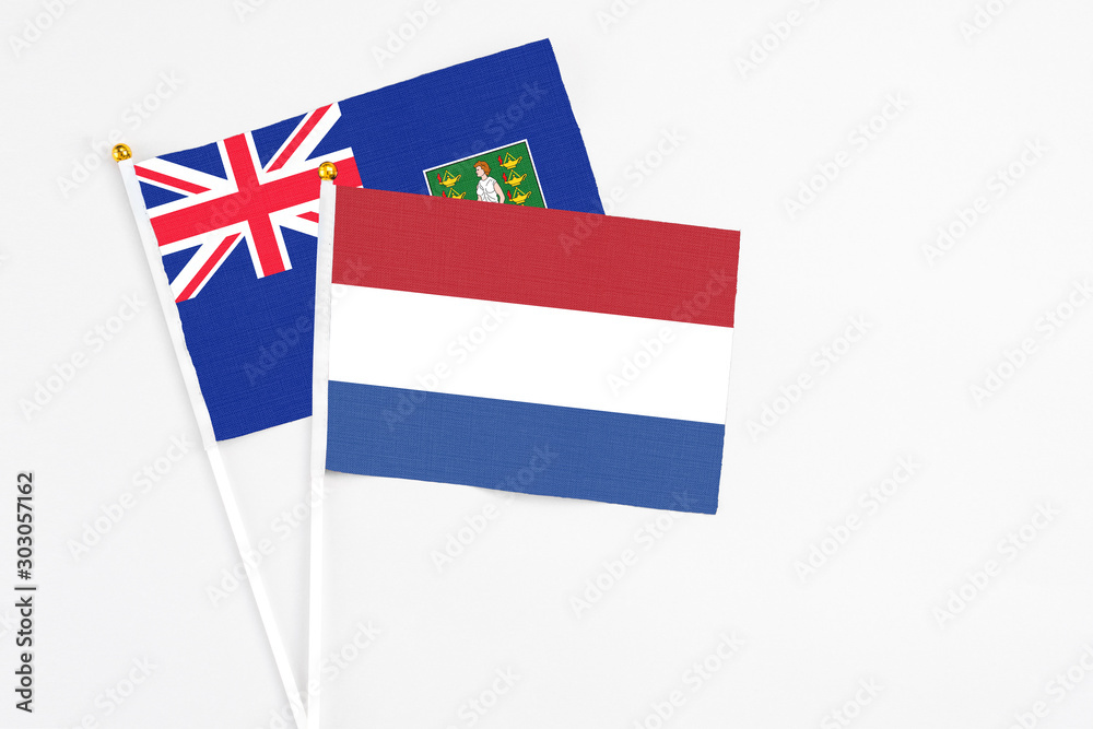 Netherlands and British Virgin Islands stick flags on white background. High quality fabric, miniature national flag. Peaceful global concept.White floor for copy space. Netherlands and British Virgin Islands stick flags on white background. High quality fabric, miniature national flag. Peaceful global concept.White floor for copy space.