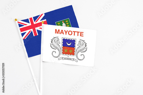 Mayotte and British Virgin Islands stick flags on white background. High quality fabric, miniature national flag. Peaceful global concept.White floor for copy space.