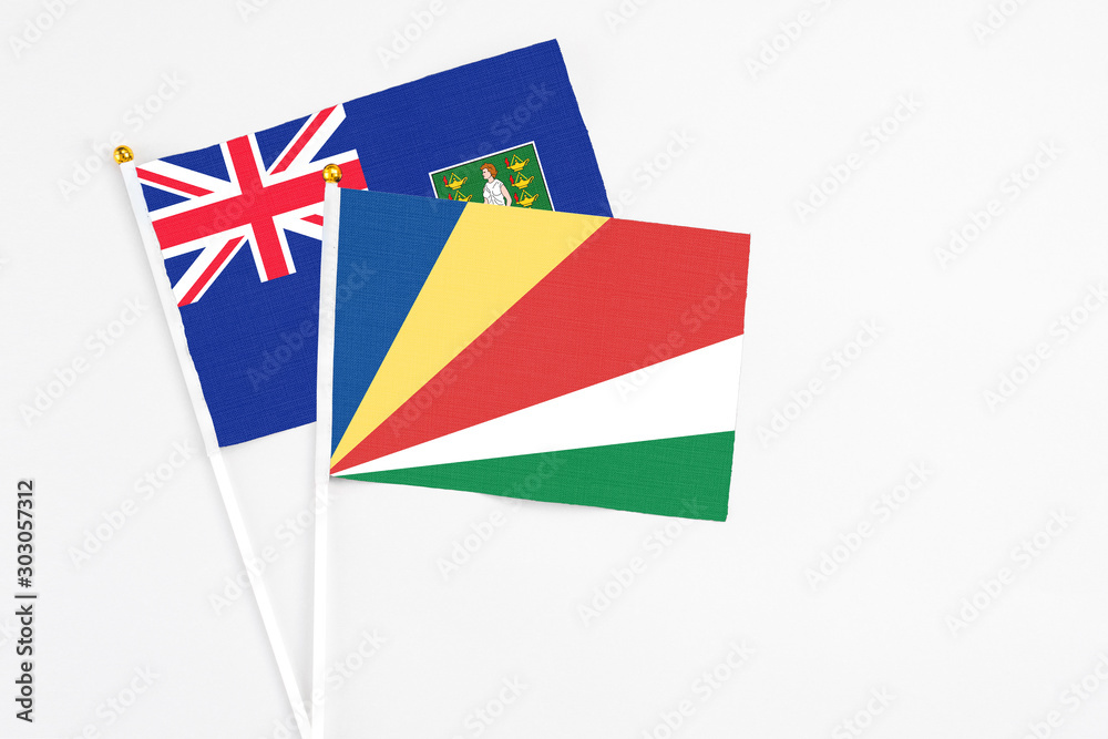 Seychelles and British Virgin Islands stick flags on white background. High quality fabric, miniature national flag. Peaceful global concept.White floor for copy space. Seychelles and British Virgin Islands stick flags on white background. High quality fabric, miniature national flag. Peaceful global concept.White floor for copy space.