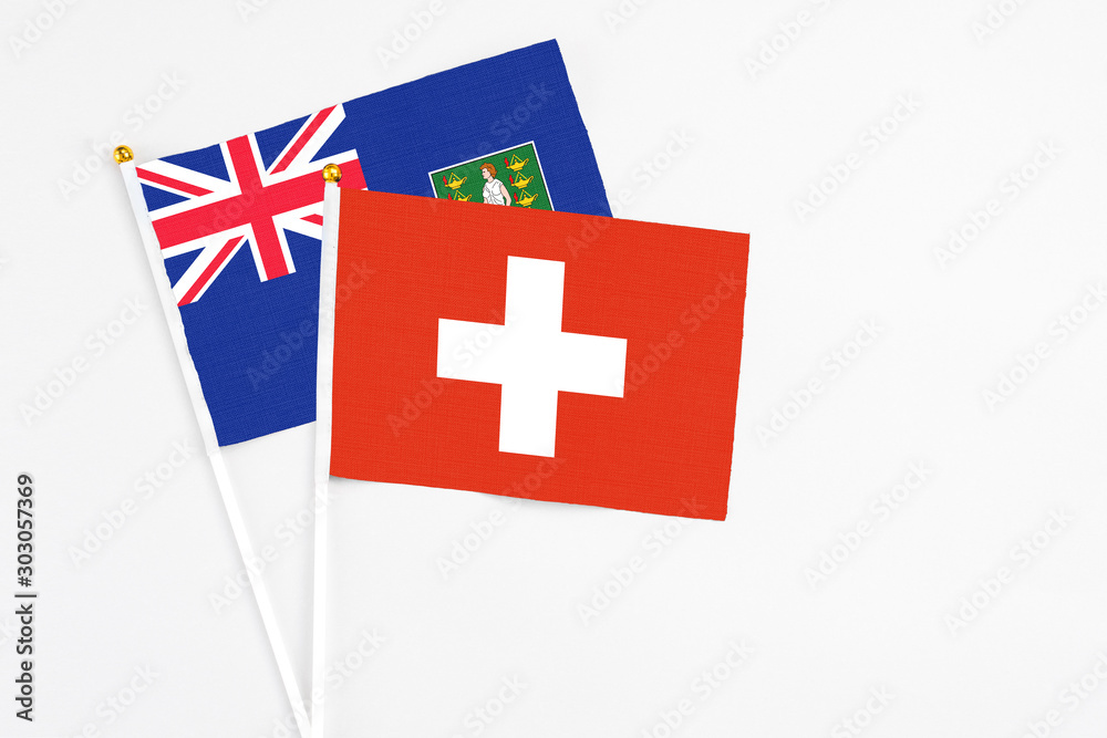 Switzerland and British Virgin Islands stick flags on white background. High quality fabric, miniature national flag. Peaceful global concept.White floor for copy space.