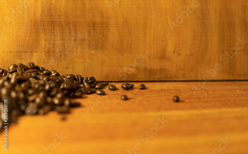 Coffee beans resting on a brown wooden table
