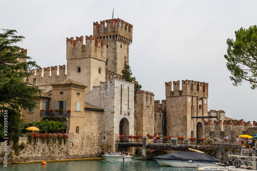 SIRMIONE / ITALY - JULY 2015: View to the medieval Rocca Scaligera castle in Sirmione town on Garda lake, Italy