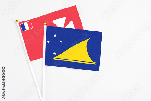 Free Download Tokelau and Wallis And Futuna stick flags on white background. High quality fabric, miniature national flag. Peaceful global concept.White floor for copy space. - GFXLoad