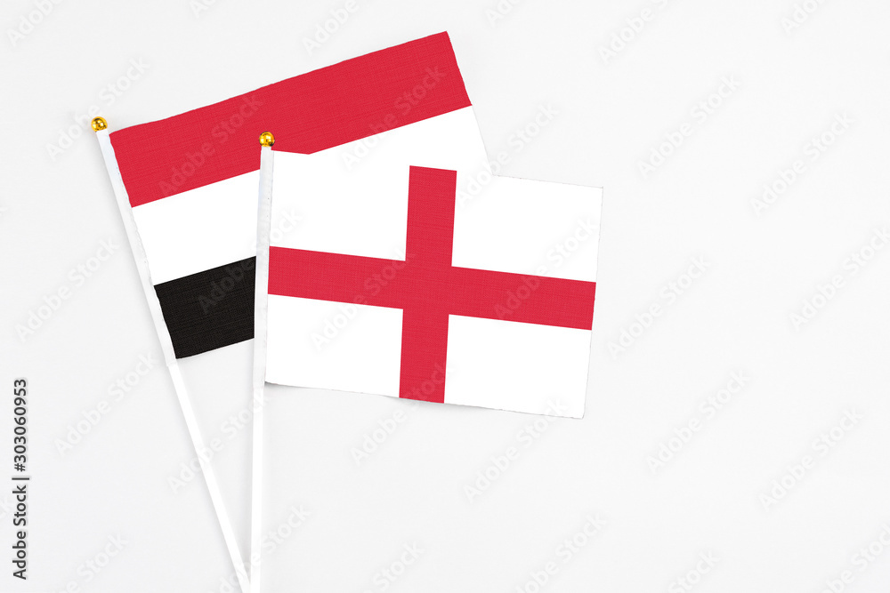England and Yemen stick flags on white background. High quality fabric, miniature national flag. Peaceful global concept.White floor for copy space.