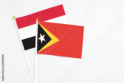 Free Download East Timor and Yemen stick flags on white background. High quality fabric, miniature national flag. Peaceful global concept.White floor for copy space. - GFXLoad
