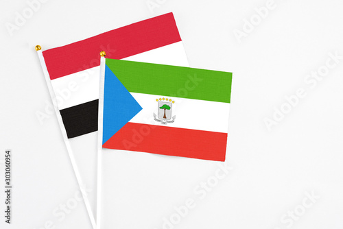 Equatorial Guinea and Yemen stick flags on white background. High quality fabric, miniature national flag. Peaceful global concept.White floor for copy space.