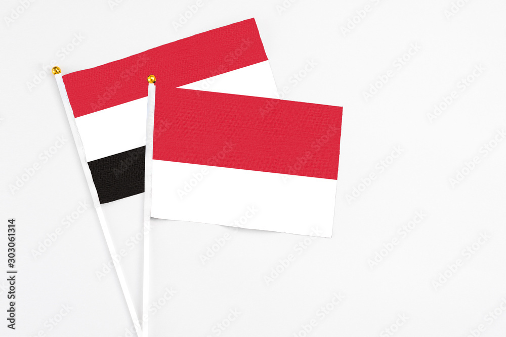 Monaco and Yemen stick flags on white background. High quality fabric, miniature national flag. Peaceful global concept.White floor for copy space. Monaco and Yemen stick flags on white background. High quality fabric, miniature national flag. Peaceful global concept.White floor for copy space.