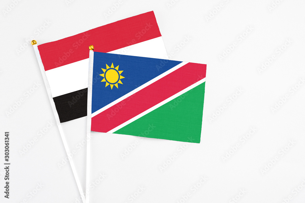 Namibia and Yemen stick flags on white background. High quality fabric, miniature national flag. Peaceful global concept.White floor for copy space. Namibia and Yemen stick flags on white background. High quality fabric, miniature national flag. Peaceful global concept.White floor for copy space.