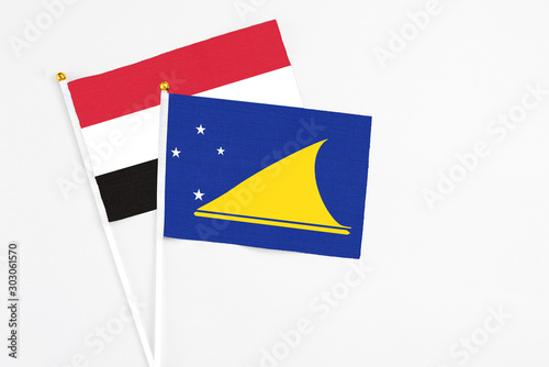 Free Download Tokelau and Yemen stick flags on white background. High quality fabric, miniature national flag. Peaceful global concept.White floor for copy space. - GFXLoad