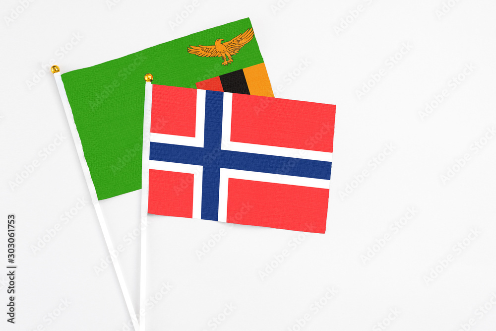 Bouvet Islands and Zambia stick flags on white background. High quality fabric, miniature national flag. Peaceful global concept.White floor for copy space.