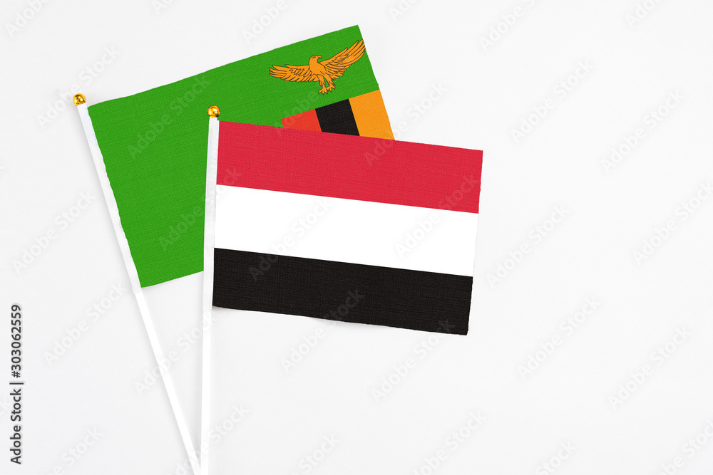 Yemen and Zambia stick flags on white background. High quality fabric, miniature national flag. Peaceful global concept.White floor for copy space. Yemen and Zambia stick flags on white background. High quality fabric, miniature national flag. Peaceful global concept.White floor for copy space.