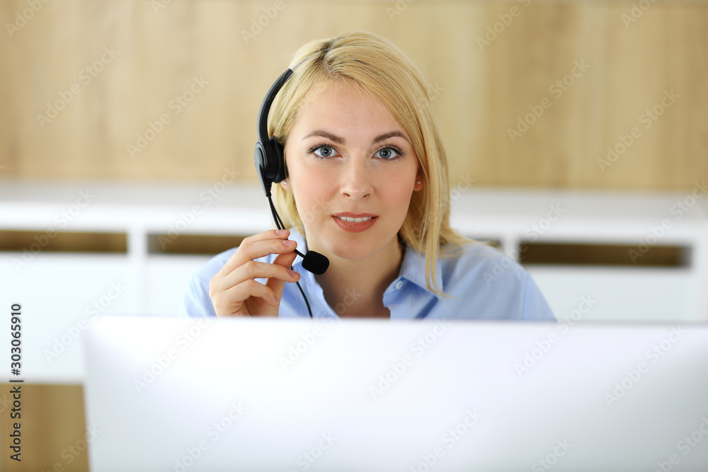 Call center. Blonde business woman sitting in headset at customer service office. Concept of telesales business or home office occupation Call center. Blonde business woman sitting in headset at customer service office. Concept of telesales business or home office occupation
