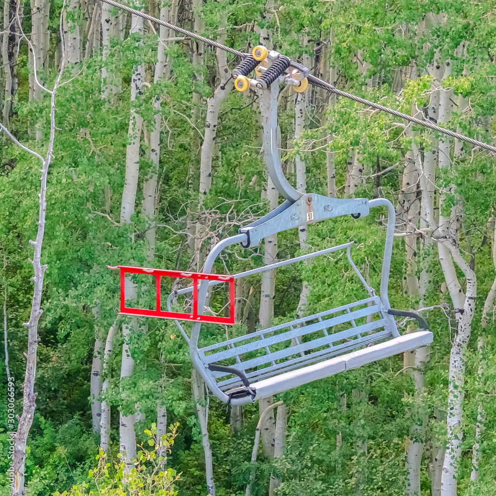 Square Chairlifts over mountain and trees on a sunny summer day in Park City ski resort Square Chairlifts over mountain and trees on a sunny summer day in Park City ski resort