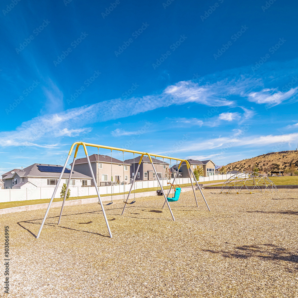 Fototapeta premium Square A-frame swings in a kids playground during day
