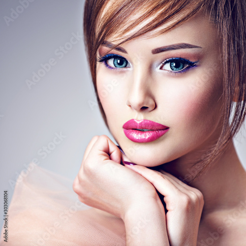 Attractive young woman with beautiful big blue eyes.