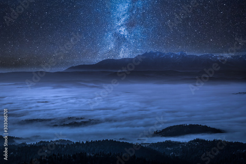 Stunning milky way and foggy walley in Tatra Mountains