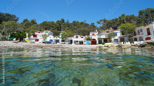 Sea shore with fishermen houses and boats on the Mediterranean coast in Spain, Costa Brava, Cala s'Alguer, Palamos, Catalonia