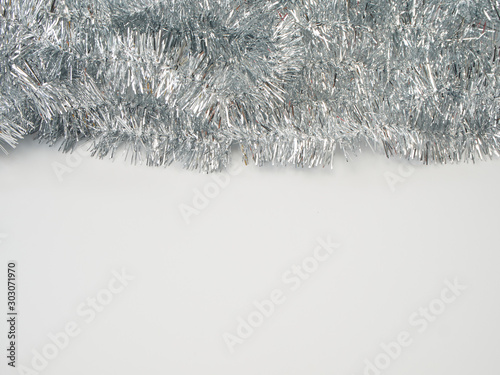 Garlands of silver tinsel on white background