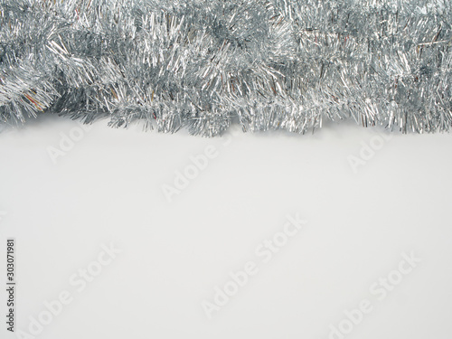 Garlands of silver tinsel on white background