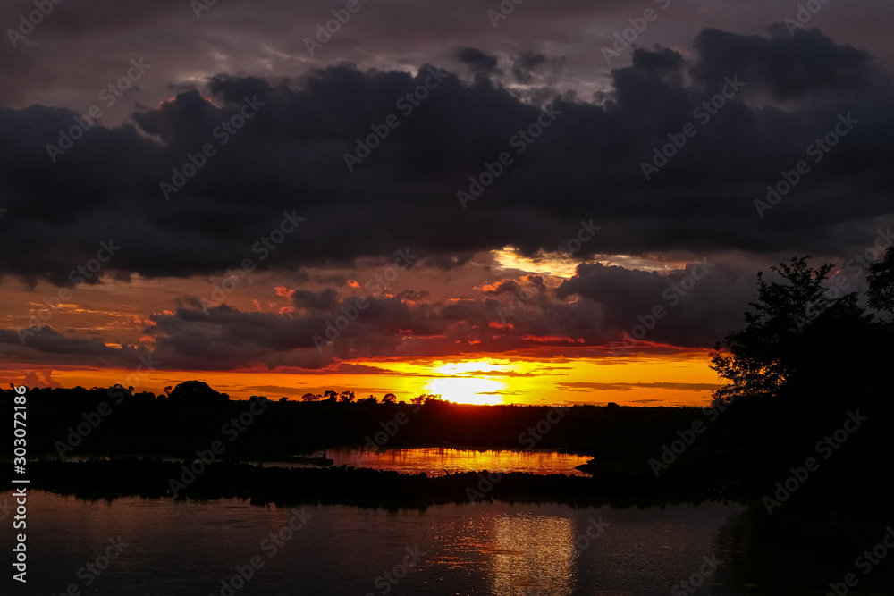 Fototapeta premium Moody sunset over a river in Pantanal Wetlands, Mato Grosso, Brazil
