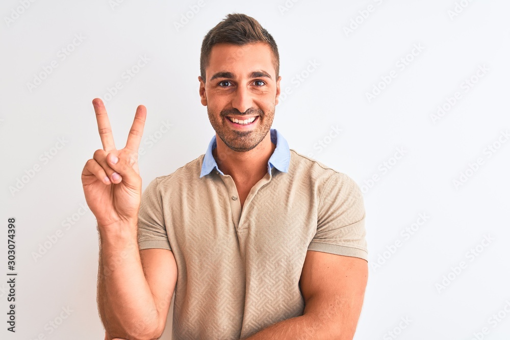 Young handsome man wearing elegant t-shirt over isolated background smiling with happy face winking at the camera doing victory sign. Number two. Young handsome man wearing elegant t-shirt over isolated background smiling with happy face winking at the camera doing victory sign. Number two.