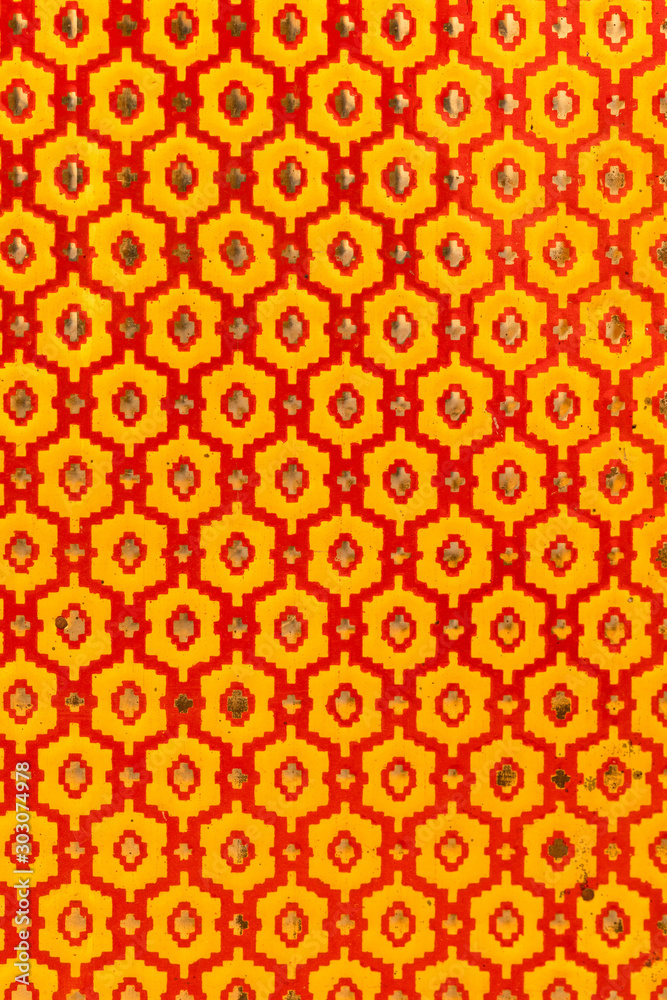Fototapeta premium Metallic texture of red and yellow hexagons. Pattern. Retro look, old and shiny.