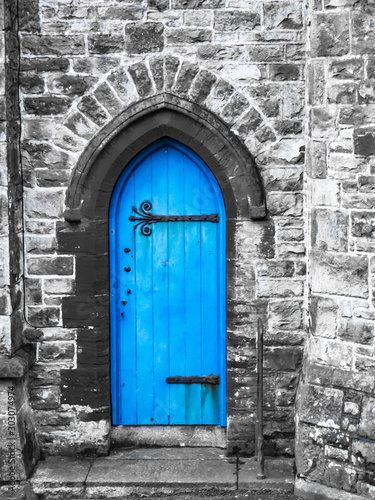 A blue church door Penzance Cornwall with saturated blue and grey stonework