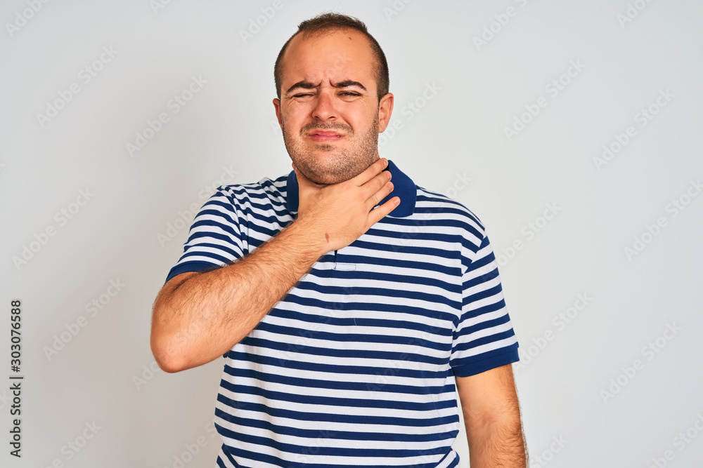 Young man wearing casual striped polo standing over isolated white background cutting throat with hand as knife, threaten aggression with furious violence Young man wearing casual striped polo standing over isolated white background cutting throat with hand as knife, threaten aggression with furious violence