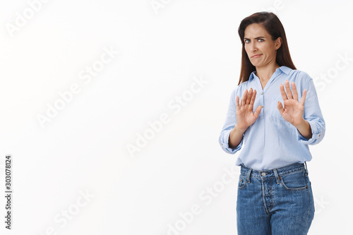 Gosh take it away. Reluctant bothered brunette middle-aged woman tilt away, raise hands refusal, rejection block gesture, smirk aversion dislike, grimacing displeased, irritated strange proposal photo