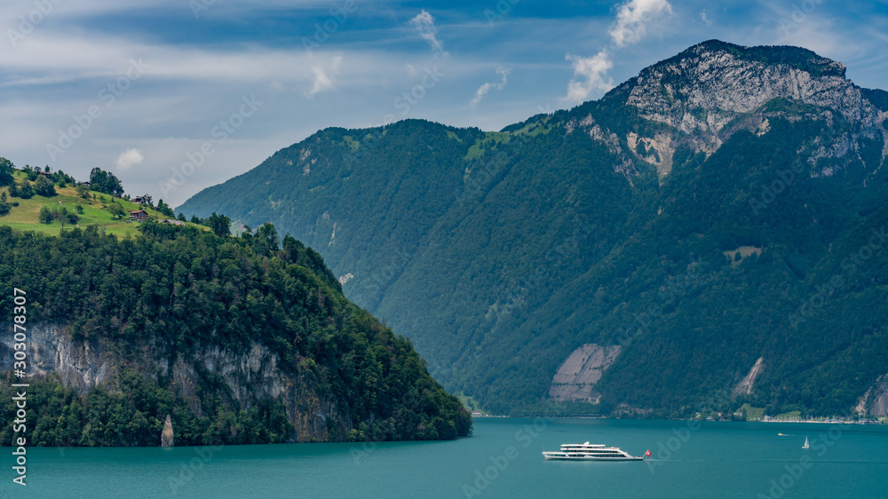 Switzerland, Panoramic view on green Swiss Alps and boat on lake Lucerne