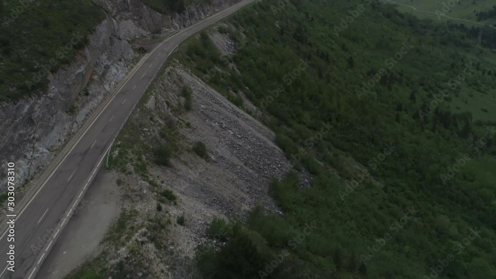 Aerial tilt up shot of a road between the mountains of Baqueira. Aerial tilt up shot of a road between the mountains of Baqueira.