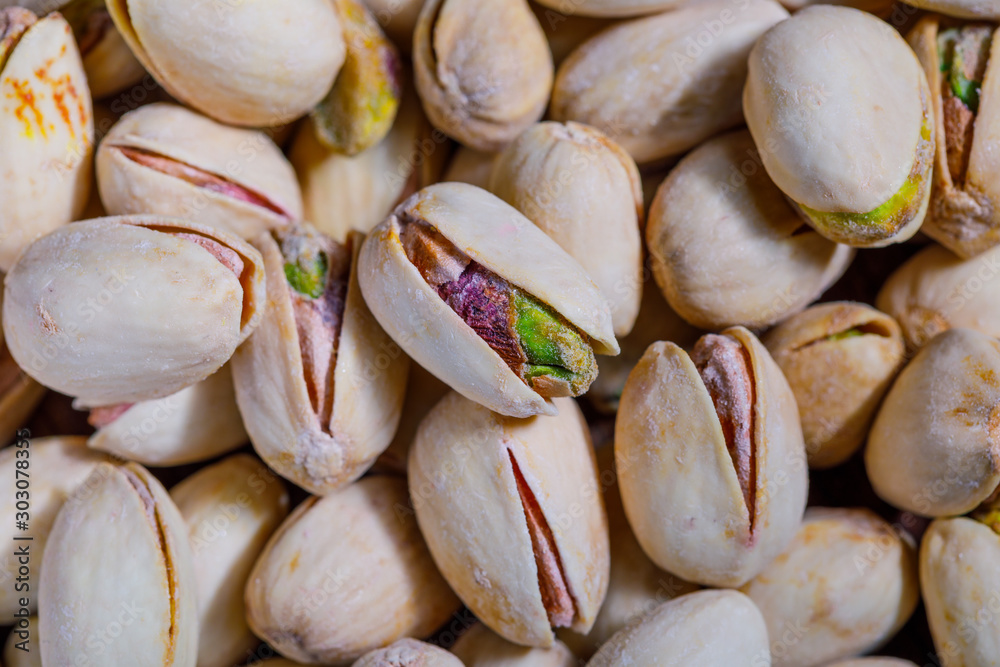 Fresh salted pistachios closeup, detailed macro image texture background