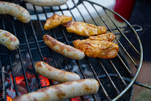 Grilled food on the grill with glowing charcoal