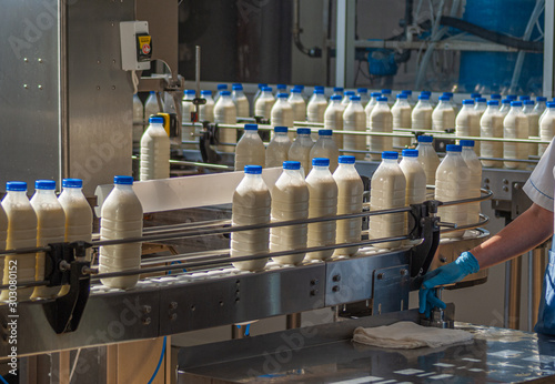 the machine pours milk into bottles