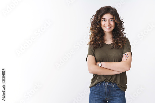 Cute confident successful young female diatologist with curly hair cross arms chest self-assured ready give helpful advice smiling broadly feel lucky day, standing white background