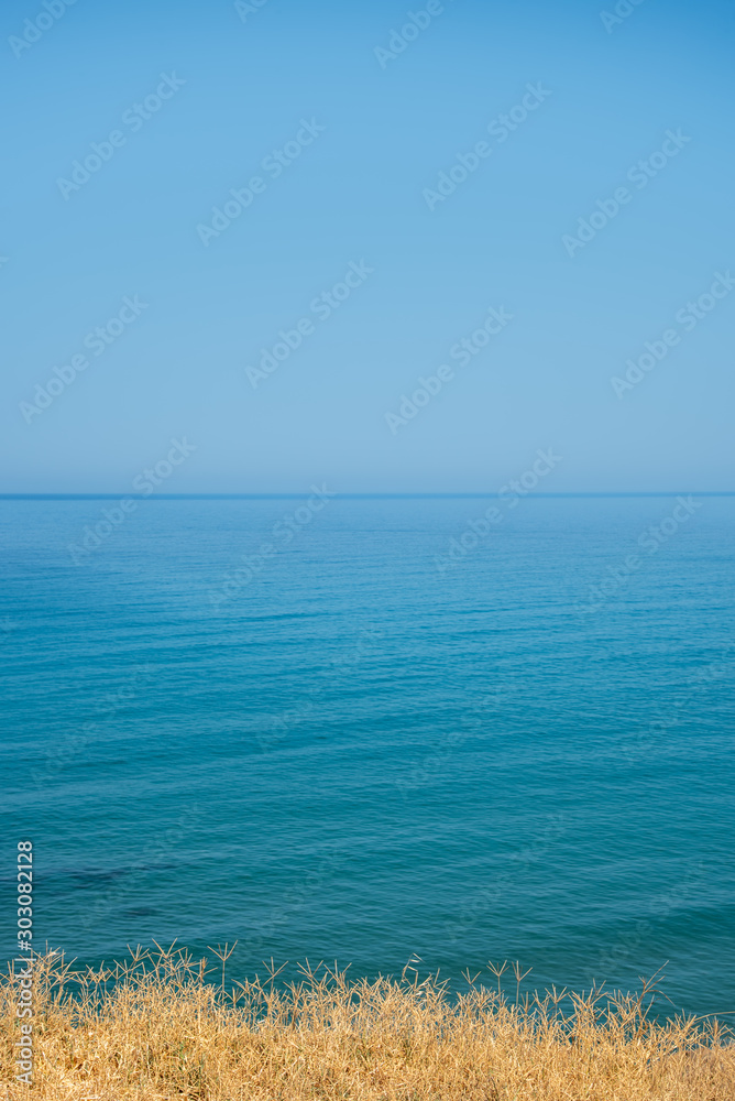Blue tranquil calm sea and clear blue sky