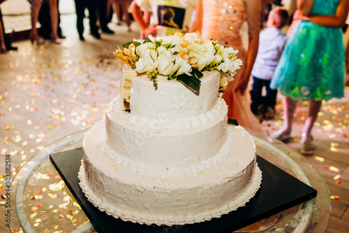 White cake decorated for a wedding celebration of love, making the classic wedding cake look with flowers decorations