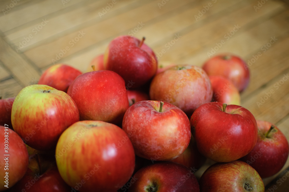 Sweet ripe red juicy apples on wooden background, healthy eating and vegetarian lifestyle concepts. Sweet ripe red juicy apples on wooden background, healthy eating and vegetarian lifestyle concepts.
