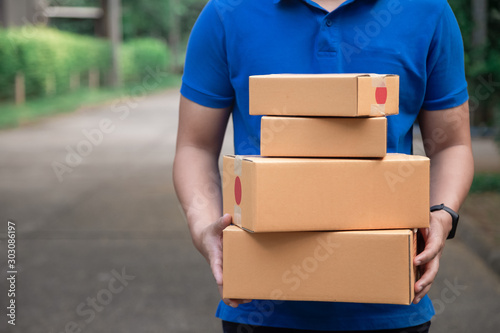 Delivery man holding boxes / copy space at home