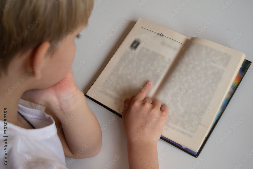 A child reading a book. Training. Children's books. Education of children. A child reading a book. Training. Children's books. Education of children.