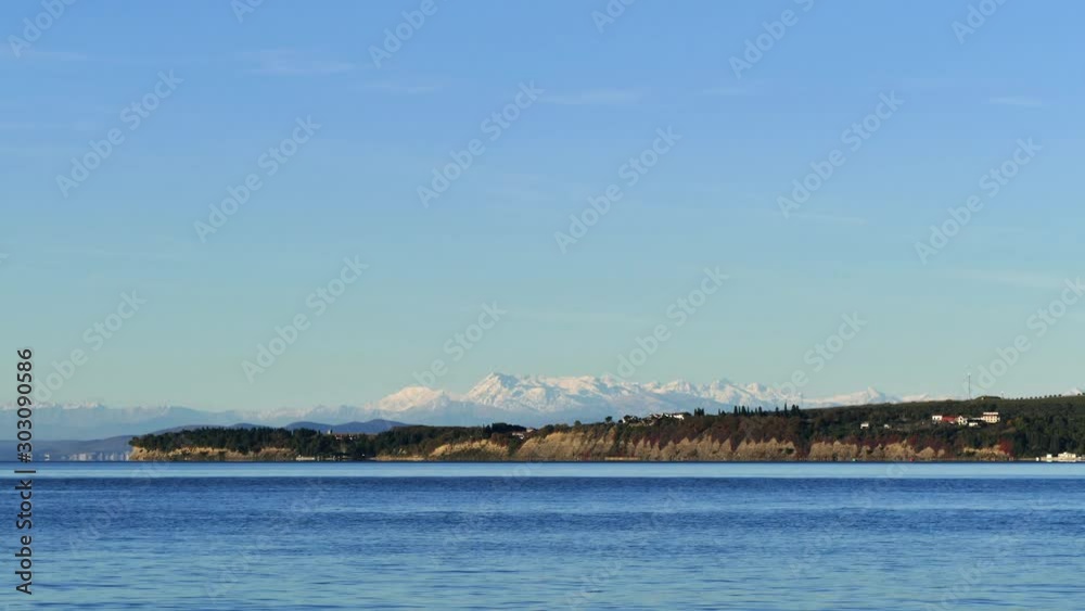 View from sea towards Alps mountains range covered with snow, time lapse, UHD View from sea towards Alps mountains range covered with snow, time lapse, UHD