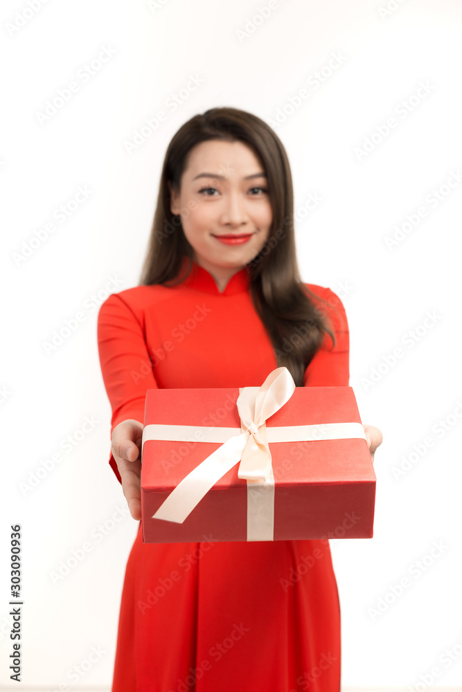 Beautiful Asian woman wear red ao dai dress, happy smile hold new year gift box present, in isolated on white background Beautiful Asian woman wear red ao dai dress, happy smile hold new year gift box present, in isolated on white background