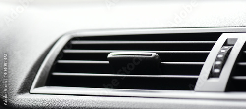 Car climatronic or air conditioner. Vehicle ventilation grille detail. photo
