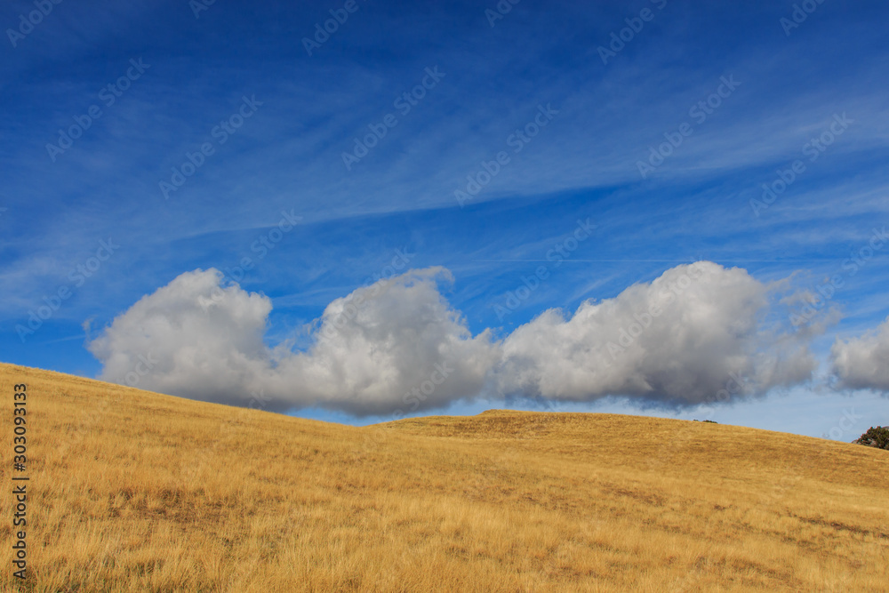 Clouds with shapes in blue sky with brown mountain.Nature concept