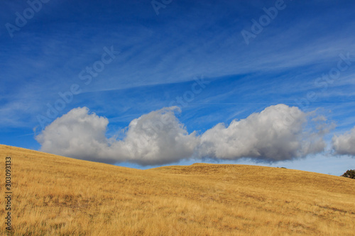 Clouds with shapes in blue sky with brown mountain.Nature concept