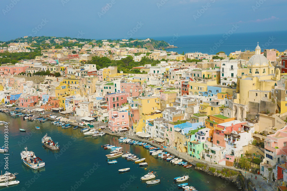 Stunning view of Procida in sunny summer day. Colorful houses, fishing boats and yachts in Marina Corricella, Procida Island, Italy.